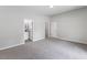 Inviting main bedroom with fresh paint and soft carpet, leading into the ensuite bathroom at 714 Harriett St, Henderson, NC 27536
