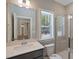 Bright bathroom featuring a glass shower, white vanity and a bright window with view at 72 Merle Way, Wendell, NC 27591