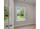 Bright bedroom with a large window view, hardwood floors, and neutral wall paint at 72 Merle Way, Wendell, NC 27591