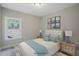 Bedroom featuring a bed, side tables, lamps, and a window with view to the yard at 72 Merle Way, Wendell, NC 27591