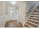 Bright entryway featuring a staircase, door, and wood floors at 72 Merle Way, Wendell, NC 27591