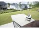 Spacious backyard with pool, green grass, patio, and modern seating area at 7736 Roberts Rd, Apex, NC 27523