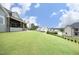 Expansive backyard with lush green grass, patio, and view of neighborhood at 7736 Roberts Rd, Apex, NC 27523