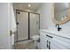 Contemporary bathroom featuring a glass-enclosed shower and a white vanity with black hardware at 7736 Roberts Rd, Apex, NC 27523
