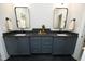 Stylish bathroom featuring a double sink vanity with dark countertops and modern fixtures at 7736 Roberts Rd, Apex, NC 27523