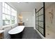 Elegant bathroom showcasing a black freestanding tub, sleek glass shower, and modern vanity at 7736 Roberts Rd, Apex, NC 27523