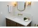 Stylish bathroom vanity with marble countertop, modern faucet, and decorative gold sconces at 7736 Roberts Rd, Apex, NC 27523