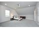 Spacious bedroom with an angled ceiling, neutral walls, and carpeted floors at 7736 Roberts Rd, Apex, NC 27523