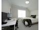 Cozy bedroom with a bed, desk area, and a neutral color palette at 7736 Roberts Rd, Apex, NC 27523