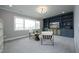 Stylish bonus room with custom built-in shelving, comfortable seating, and plenty of natural light at 7736 Roberts Rd, Apex, NC 27523