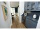 Butler pantry featuring stylish blue cabinets, a built-in wine fridge, and sleek countertops at 7736 Roberts Rd, Apex, NC 27523