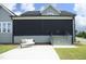 Two-story home with covered patio and roll-down shades, complemented by a cozy outdoor seating area at 7736 Roberts Rd, Apex, NC 27523