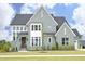 Stunning two-story home showcasing a modern design with a well-manicured lawn and multiple windows at 7736 Roberts Rd, Apex, NC 27523
