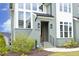 Home featuring an inviting front door with stylish lanterns, landscaped shrubs, and elegant brickwork at 7736 Roberts Rd, Apex, NC 27523