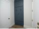 Hallway with a built-in, blue cabinet for extra storage and light hardwood floors at 7736 Roberts Rd, Apex, NC 27523