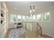 Bright hallway with natural light, decorative rug, and stairway at 7736 Roberts Rd, Apex, NC 27523