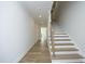 Bright hallway with hardwood floors and stairs leading to the upper level at 7736 Roberts Rd, Apex, NC 27523