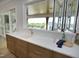 Kitchen bar area with bi-fold windows and view of the outdoor living space and backyard at 7736 Roberts Rd, Apex, NC 27523