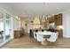 Eat-in kitchen featuring a stone accent wall, a central island, and sliding doors to the outdoors at 7736 Roberts Rd, Apex, NC 27523