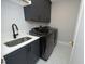Efficient laundry room with modern appliances, sink, and stylish tile flooring at 7736 Roberts Rd, Apex, NC 27523