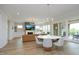 Spacious living room with a fireplace, complemented by a round dining table and hardwood floors at 7736 Roberts Rd, Apex, NC 27523