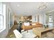 Bright, open-concept living area with a light-filled interior, wood floors, and sliding glass doors to the outside at 7736 Roberts Rd, Apex, NC 27523