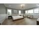 Spacious bedroom with hardwood floors, stylish decor, large windows, and modern lighting at 7736 Roberts Rd, Apex, NC 27523
