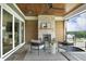 Covered patio with a stone fireplace, comfortable seating, and a view of the backyard at 7736 Roberts Rd, Apex, NC 27523