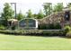 Elegant community entrance sign surrounded by lush greenery and a stone wall at 7736 Roberts Rd, Apex, NC 27523