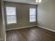 Bedroom with wood flooring, two windows with blinds, ceiling fan and neutral walls at 78 Ariel Street, Lillington, NC 27546
