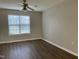 Well-lit bedroom with modern flooring, a ceiling fan, and a view through a large window at 78 Ariel Street, Lillington, NC 27546