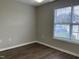 Bedroom featuring wood flooring, a window with blinds, and neutral wall paint at 78 Ariel Street, Lillington, NC 27546