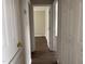 Hallway with wood floors leads to an adjacent room, with neutral colored walls at 78 Ariel Street, Lillington, NC 27546