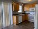 Modern kitchen with wood cabinets, and stainless steel appliances, and space saving blinds at 78 Ariel Street, Lillington, NC 27546
