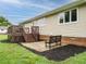 The backyard features a wooden deck with steps, a small patio with a bench, and a neatly kept lawn at 8204 Charlbert Ct, Apex, NC 27539