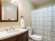 Bathroom features a vanity with sink, toilet, and shower with a patterned curtain at 8204 Charlbert Ct, Apex, NC 27539
