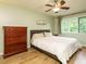 Bedroom with hardwood floors, a ceiling fan, a window, and a dresser at 8204 Charlbert Ct, Apex, NC 27539