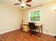 Bedroom with hardwood floors, a ceiling fan, a window, and a desk with rolling chair at 8204 Charlbert Ct, Apex, NC 27539