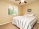 Cozy bedroom with a window, carpet, and a bed with striped bedding at 8204 Charlbert Ct, Apex, NC 27539