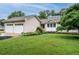Charming single-story home featuring a well-manicured lawn, front garden, and a two-car garage at 8204 Charlbert Ct, Apex, NC 27539