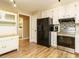 Eat-in kitchen features white cabinets, stainless appliances, and wood-look flooring at 8204 Charlbert Ct, Apex, NC 27539