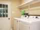 Laundry room features modern washer and dryer and access to outside at 8204 Charlbert Ct, Apex, NC 27539