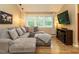 Inviting living room featuring a comfortable sectional sofa, hardwood floors, and a television at 8204 Charlbert Ct, Apex, NC 27539