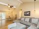 Open-concept living room with vaulted ceilings, hardwood floors, and comfortable seating area at 8204 Charlbert Ct, Apex, NC 27539