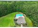 Aerial view of the community pool and pool house surrounded by dense trees at 85 Pebble Creek Dr, Franklinton, NC 27525