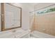 Cozy bathroom featuring tiled shower and bathtub combination and a single sink vanity and mirror at 85 Pebble Creek Dr, Franklinton, NC 27525