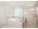 Luxurious bathroom featuring separate shower and soaking tub with tile surround at 85 Pebble Creek Dr, Franklinton, NC 27525