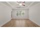 Bright bedroom with ceiling fan, tray ceiling, neutral paint, and large window offering an abundance of natural light at 85 Pebble Creek Dr, Franklinton, NC 27525