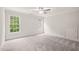 Spacious bedroom with carpet, ceiling fan, and a large window with blinds at 85 Pebble Creek Dr, Franklinton, NC 27525