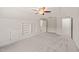 Bedroom featuring built-in shelving units, plush carpet, and a door leading to an adjoining room at 85 Pebble Creek Dr, Franklinton, NC 27525
